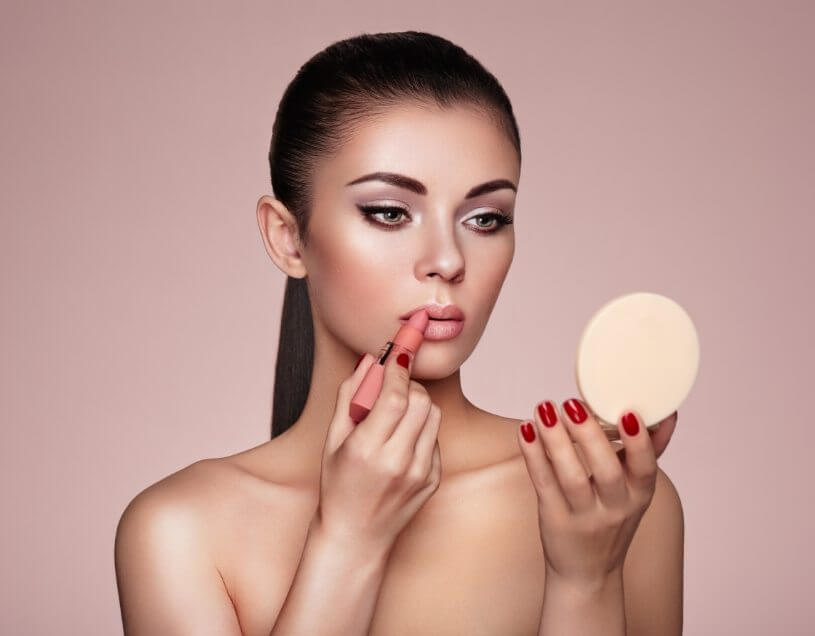 demo-attachment-1154-beautiful-woman-paints-lips-with-lipstick-PMB6YWP